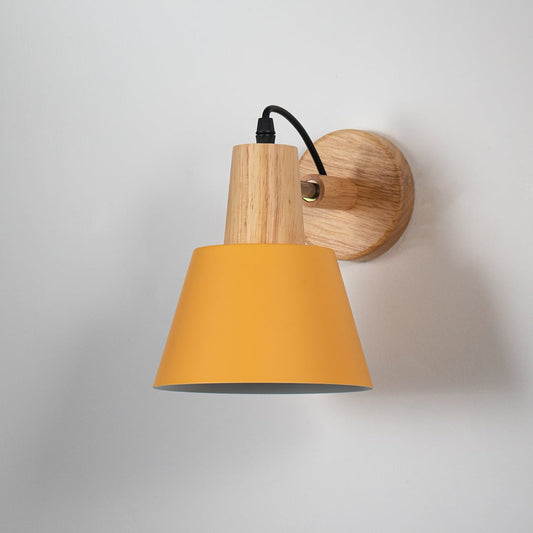 Wall sconce with matte mustard yellow shade wooden base and black cord perfect for bedroom living room and hallway walls.