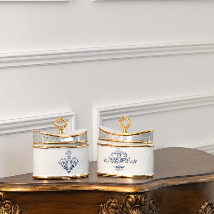White and gold rectangular ceramic jars with blue artwork in a front view ideal for elegant décor styling and modern tabletop display.