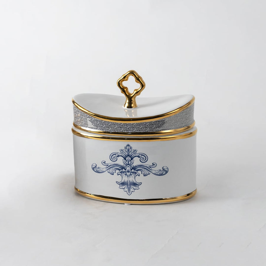 White ceramic jar with gold lid and blue artwork in a front view ideal for luxury décor styling and premium tabletop accents.