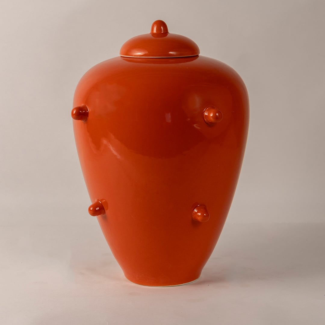 Glossy orange ceramic ginger jar with lid and decorative knobs perfect for unique home accents and interior styling.