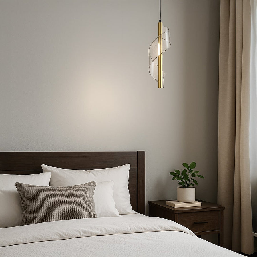 Stylish gold swirl pendant lamp illuminating a cozy reading corner adding warmth and artistic charm to interiors.