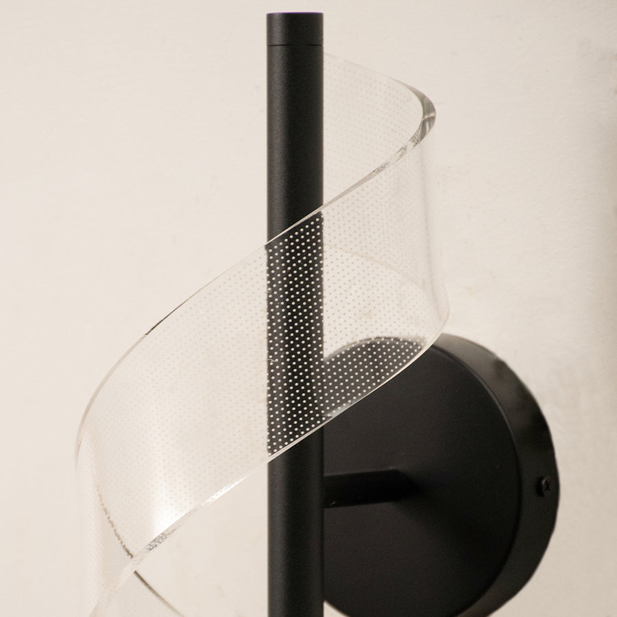 Closeup of black metal and translucent mesh wall light for elegant contemporary decor styling spaces.

