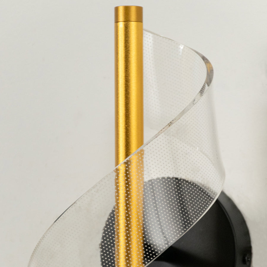 Closeup of gold metal and translucent mesh wall light for premium modern decor styling spaces.