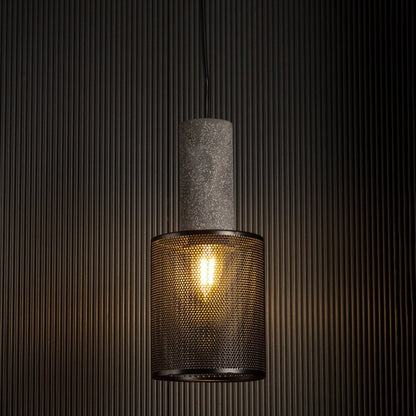 Arlo Mesh pendant light glowing against a dark background highlighting industrial texture and warm filament light.