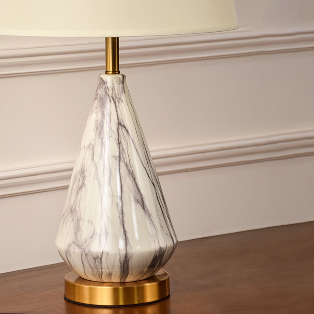 Closeup highlighting the natural marble veining golden metal base and fine shade texture showcasing craftsmanship and elegant detailing.