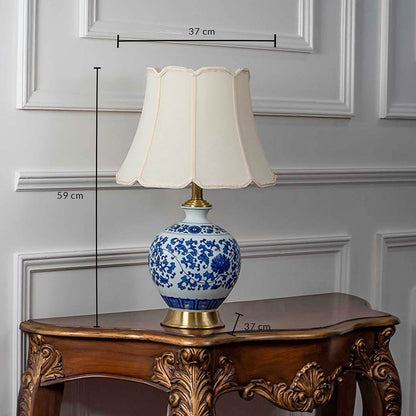 Blue and white ceramic table lamp with fabric shade measuring 49 cm height and 27 cm width for classic interiors.