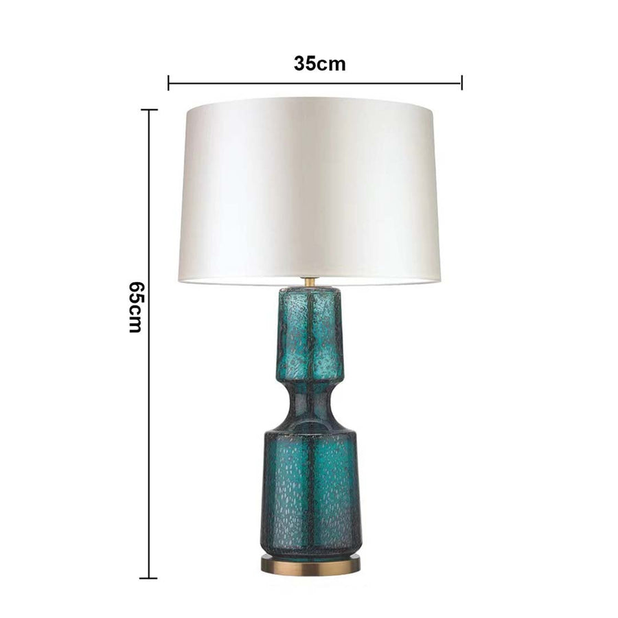 Teal glass table lamp with white shade with size 65cm height and 36cm width on white background for stylish modern décor.
