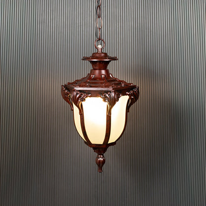 Brown hanging lantern with frosted glass glowing warmly on black background creating a classic outdoor ambience.