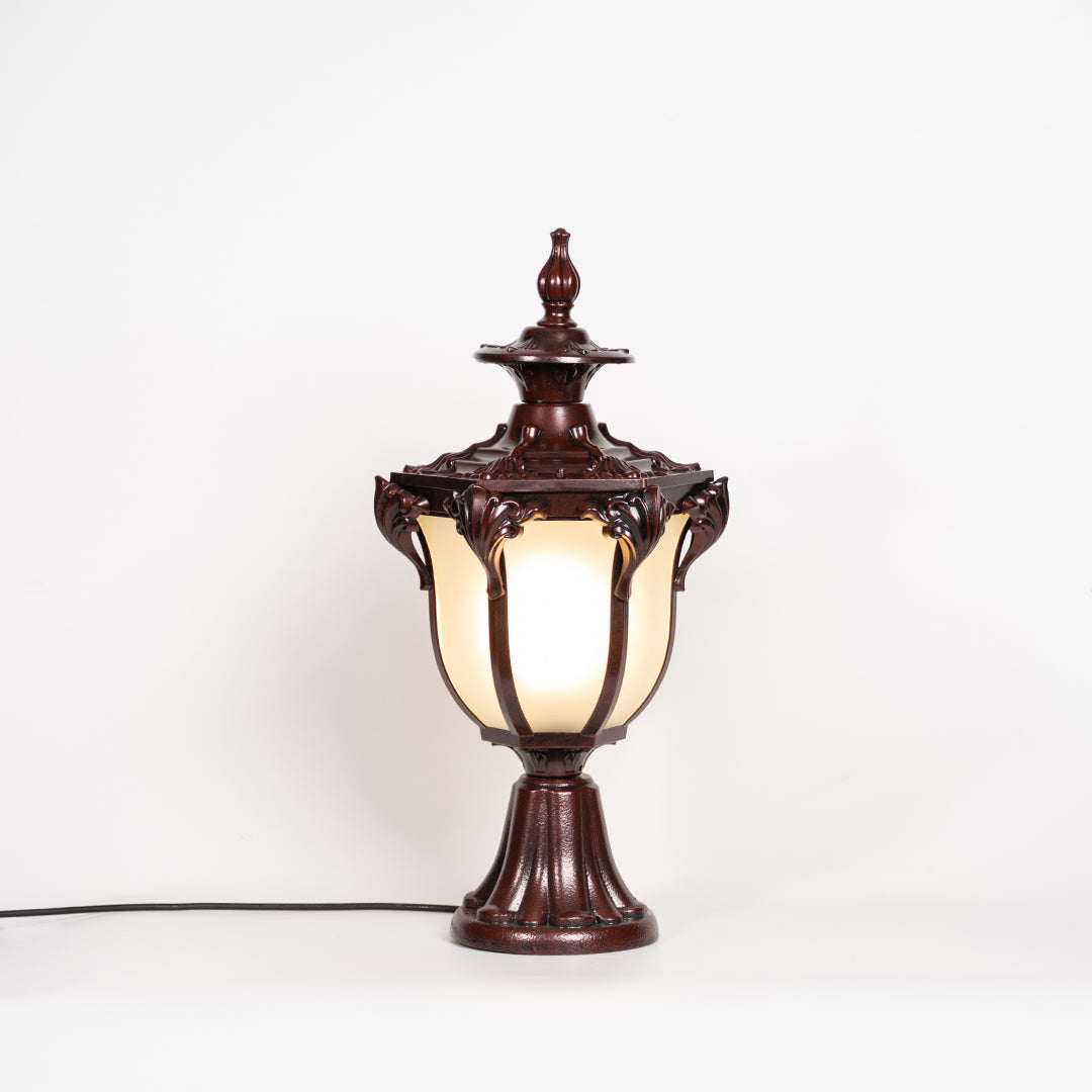 Antique brown outdoor gate light with glowing glass shade for luxury exterior decor styling use.