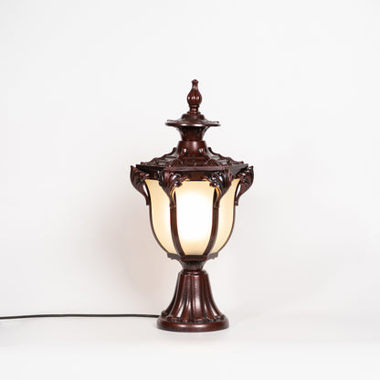 Antique brown outdoor gate light with glowing glass shade for luxury exterior decor styling use.
