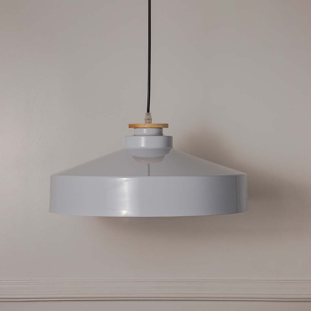 White metal pendant light with minimalist drum shade designed for stylish contemporary interiors.