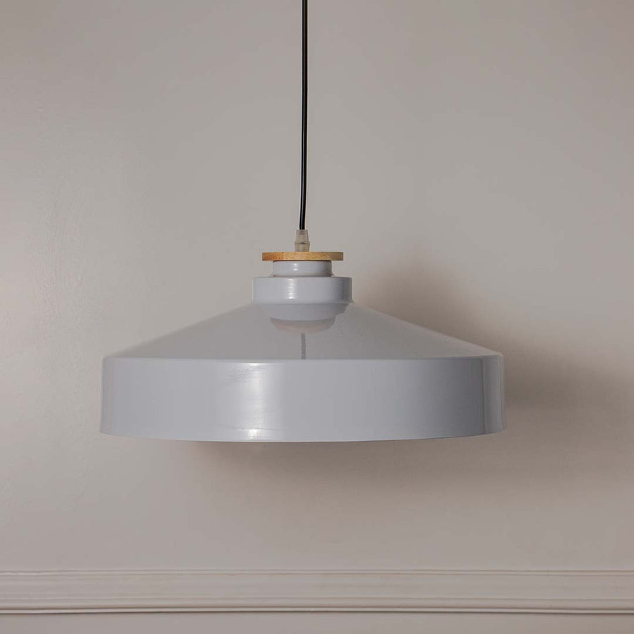 White metal pendant light with minimalist drum shade designed for stylish contemporary interiors.