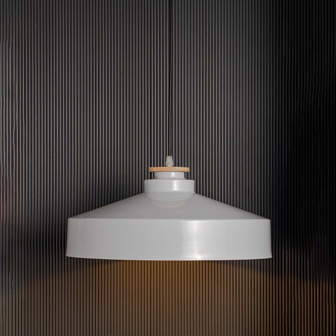 Modern white dome pendant lamp with wide metal shade and wooden detail glowing warmly on black background for decor.