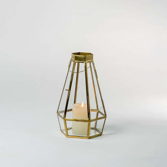 Gold metal geometric candle holder with open frame design for elegant modern tabletop decor styling.