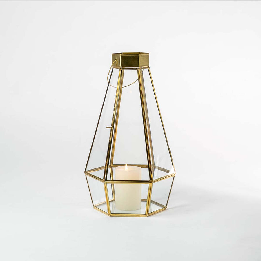 Minimal gold metal candle holder with geometric frame design for luxury tabletop decor styling.