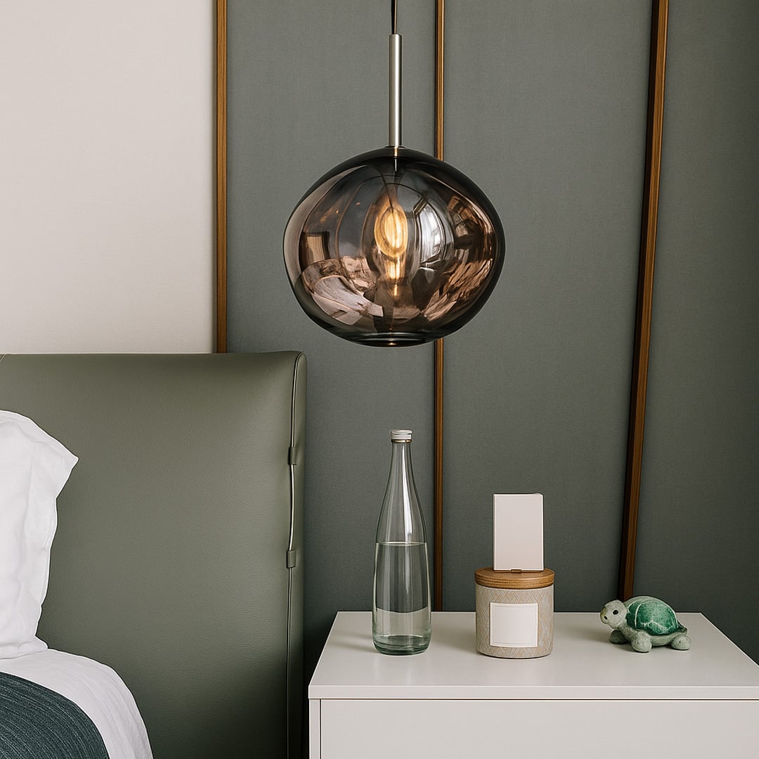 An organic shaped smoked glass pendant light glowing warmly beside a modern bedroom setup creating soft ambient lighting for contemporary interior decor.