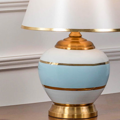 Closeup view showing the ceramic glaze and gold accents that highlight the premium craftsmanship and artistic balance of the lamp.