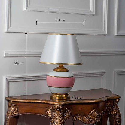 Pink ceramic table lamp with white shade shown with size 50cm height and 33cm width on white background for product details.