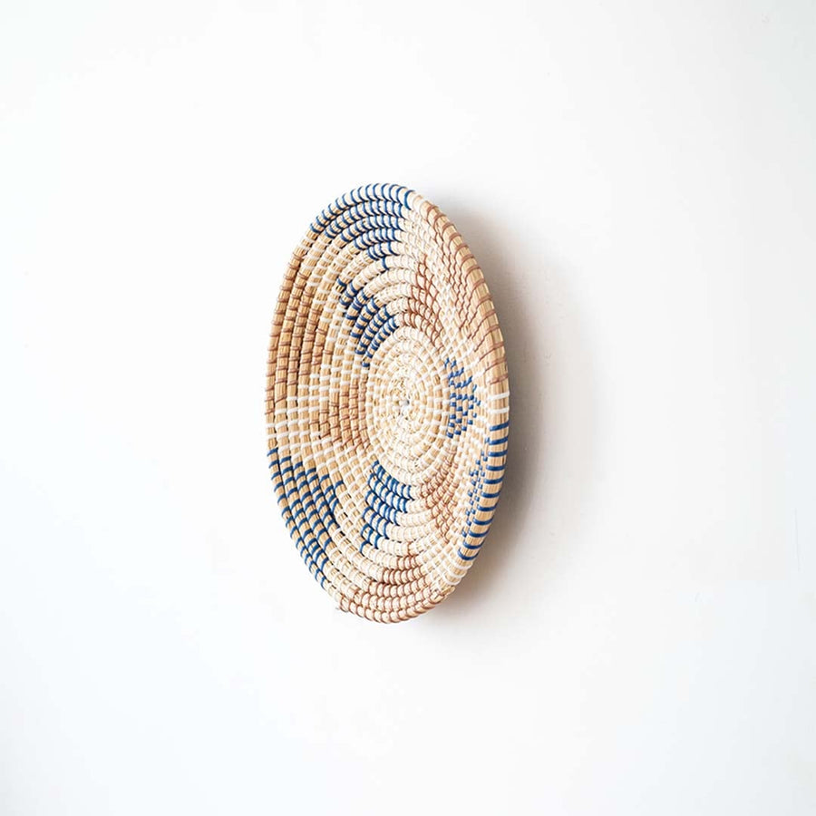 Side view of handwoven wall basket decor made of natural rustic fiber with boho design for wall styling.