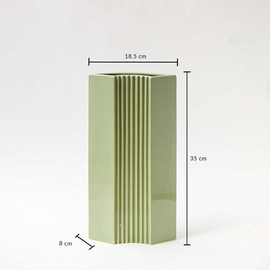 Green modern vase shown with dimensions 35 cm height 18.5 cm width and 8 cm depth highlighting its tall slim structure and ribbed detailing for accurate size reference.