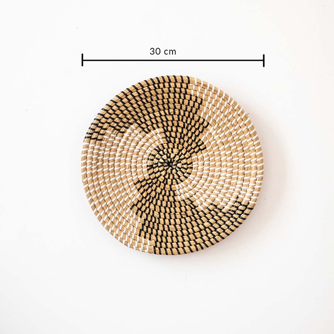 Handwoven wall basket decor in natural and black fiber shown with 30cm diameter for decorative wall placement.
