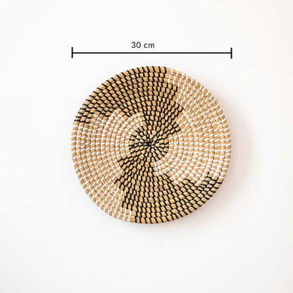 Handwoven wall basket decor in natural and black fiber shown with 30cm diameter for decorative wall placement.
