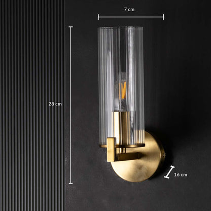 Dimensions of the gold wall sconce are clearly shown with a height of 28 cm a width of 7 cm and a base depth of 16 cm displayed on a dark background.