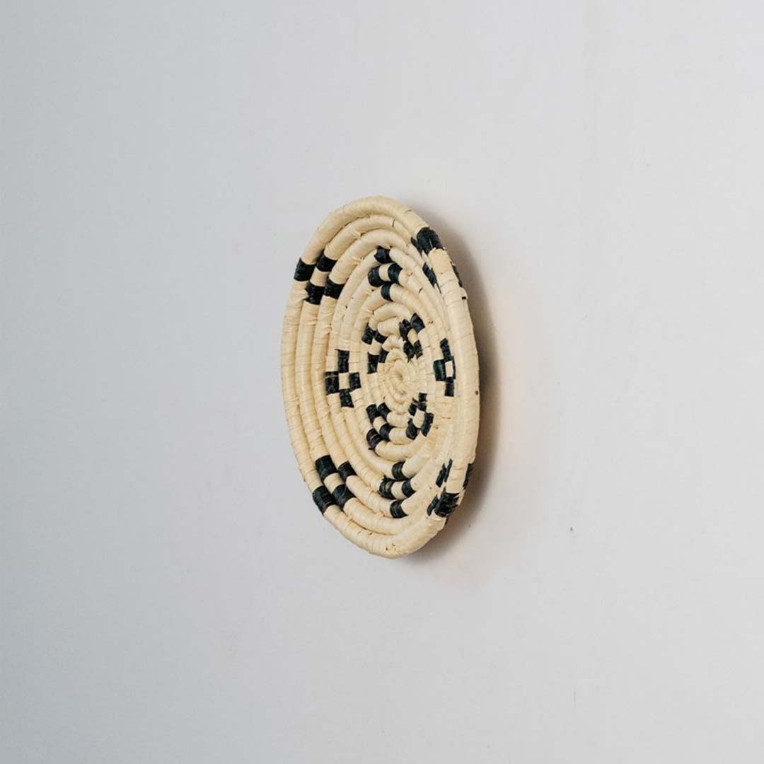 Side view of woven basket wall decor showing raised weaving details handmade texture and depth of craftsmanship.
