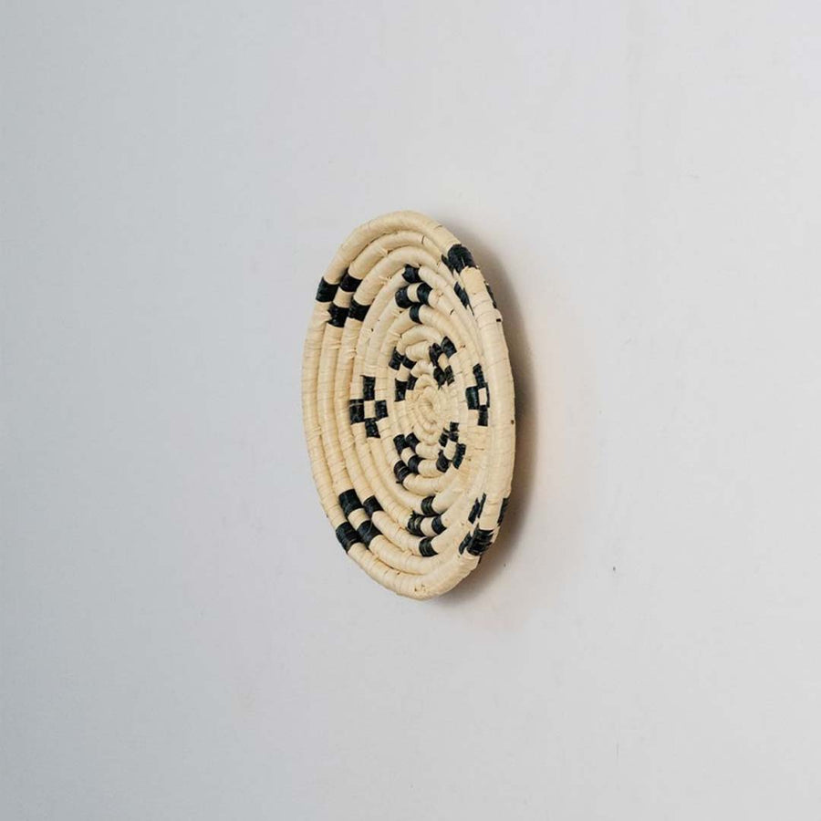 Side view of woven basket wall decor showing raised weaving details handmade texture and depth of craftsmanship.