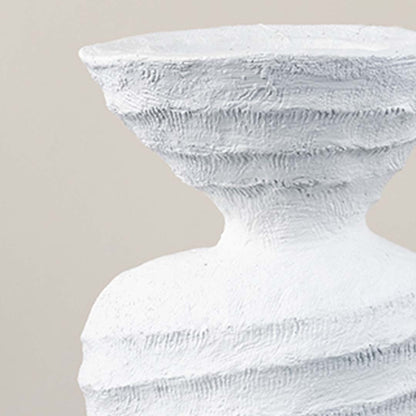 Detailed closeup of sculptural white ceramic vase highlighting textured finish for stylish interior decor.