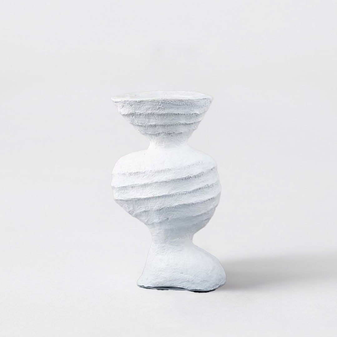 Sculptural white ceramic vase with artistic textured design modern decorative accent for table and shelf decor.