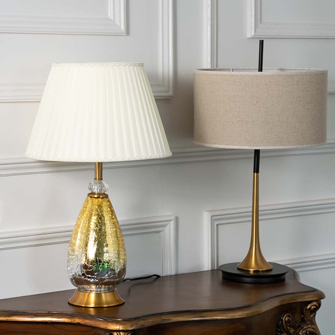 Aurora glass lamps grouped turned off with pleated white shades and golden crackle bases perfect for luxury modern home decoration.