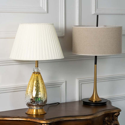 Aurora glass lamps grouped turned off with pleated white shades and golden crackle bases perfect for luxury modern home decoration.