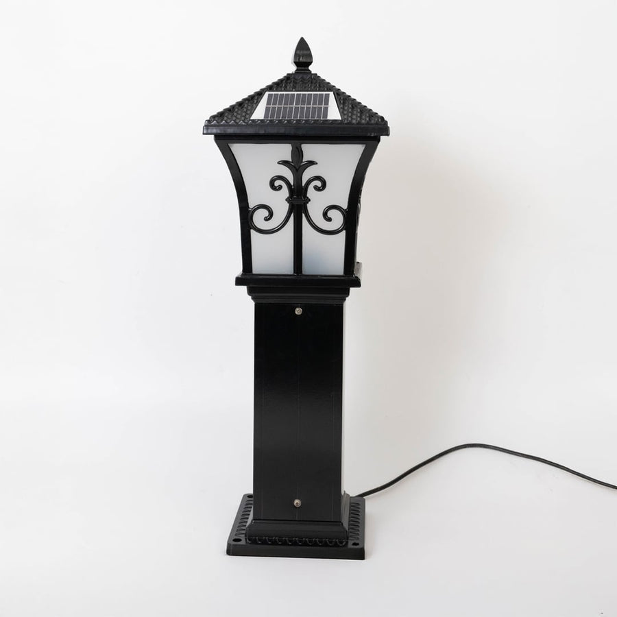 Black solar outdoor gate light with decorative glass panels for elegant exterior decor use.