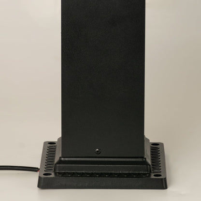 Closeup of black outdoor pillar lamp showing clear framed glass and warm filament bulb detail suitable for elegant garden and pathway lighting.
