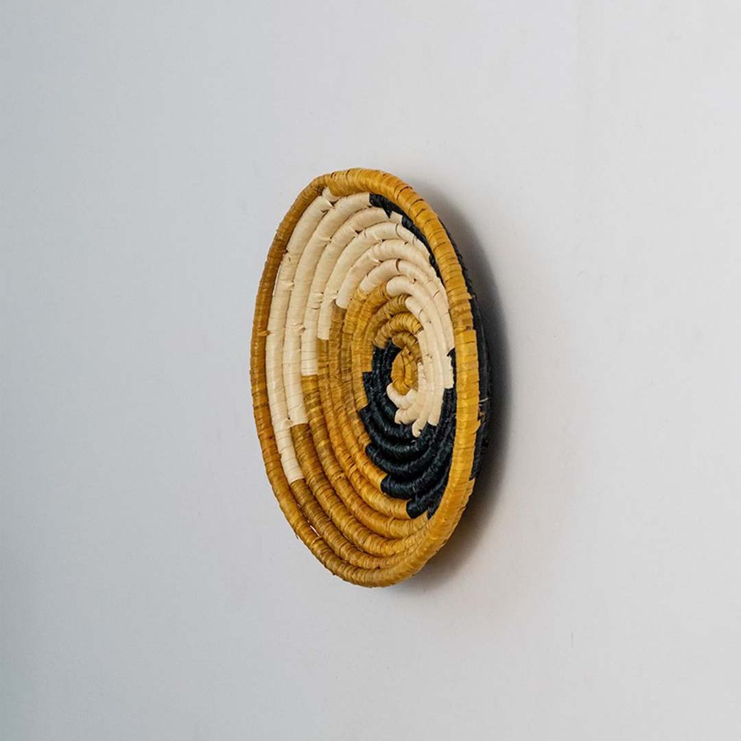 Side view of woven wall basket showing depth sturdy weave structure and natural texture perfect for wall decoration.