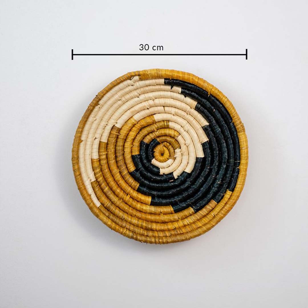 Handwoven round wall basket in yellow black and natural fiber showing 30 cm diameter designed for decorative interior wall placement.