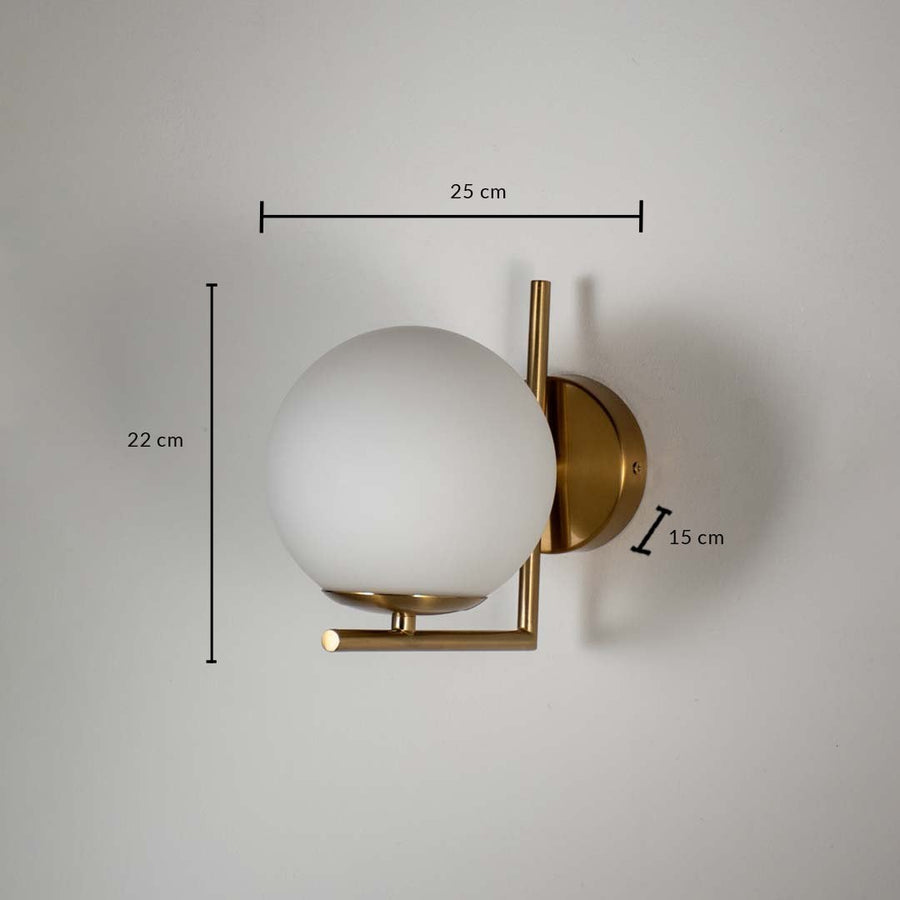 Wall lamp with gold metal frame and frosted glass globe shade shown with size 22 cm height 25 cm width and 15 cm depth.
