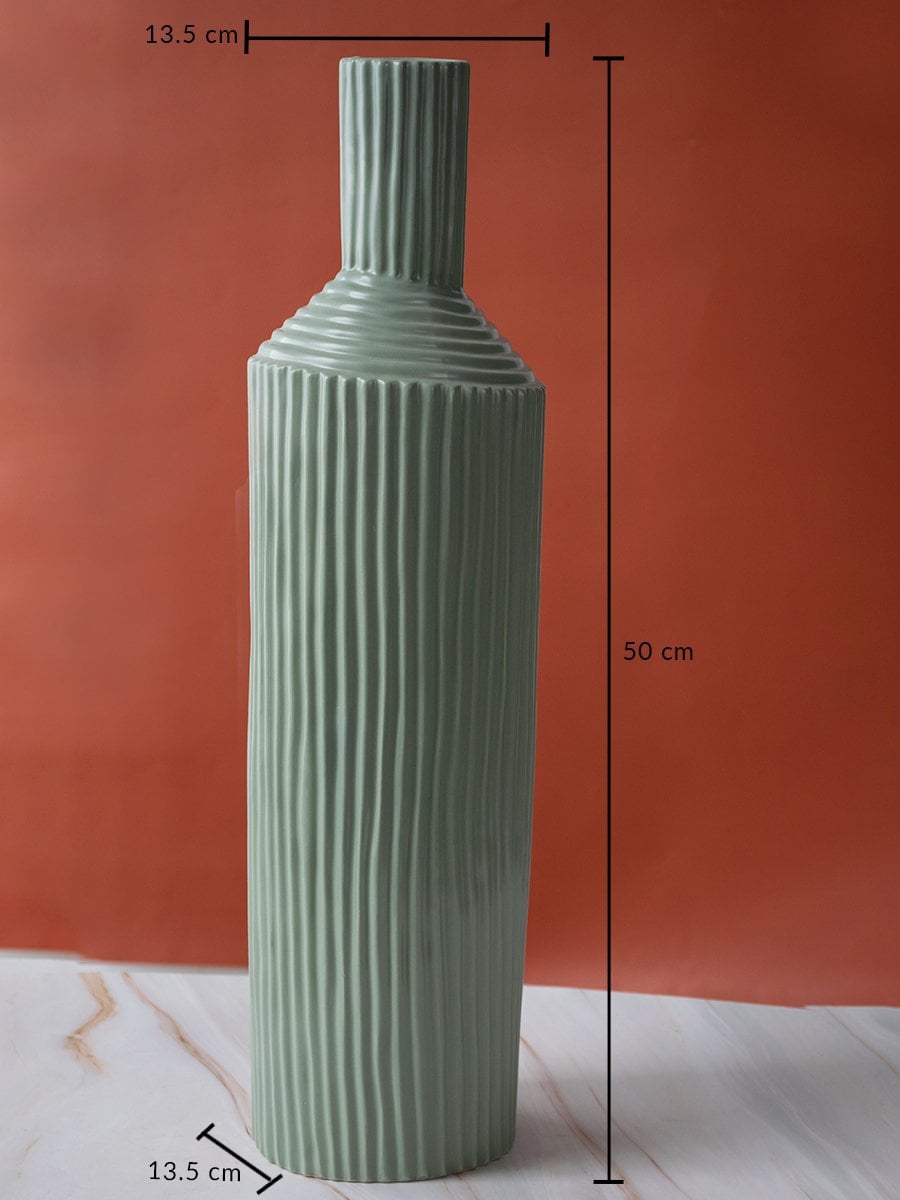 Tall ribbed green ceramic vase measuring 50 cm height and 13.5 cm width displayed clearly with size markings.