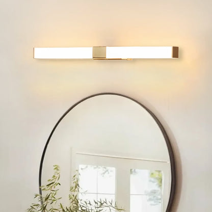 Gold LED picture light above round mirror creating warm ambient illumination and elegant hallway wall decor styling.