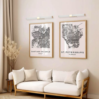 White and gold picture light styled above artwork creating warm modern illumination for elegant living room and hallway wall decor.