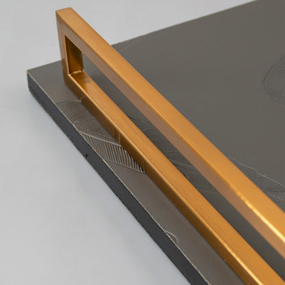 Feather tray closeup highlighting grey stone base with embossed feather pattern and sturdy gold handles for home serving.