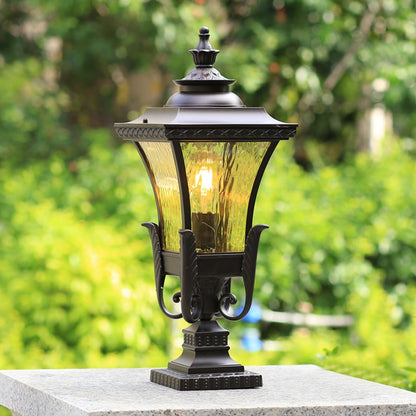 Vintage outdoor gate light styled beside green plants for elegant garden and exterior decor ambiance.
