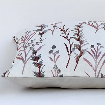 White cotton cushion cover with maroon botanical embroidery in a rectangular style offering a rich nature inspired décor accent with a smooth breathable and skin friendly texture.