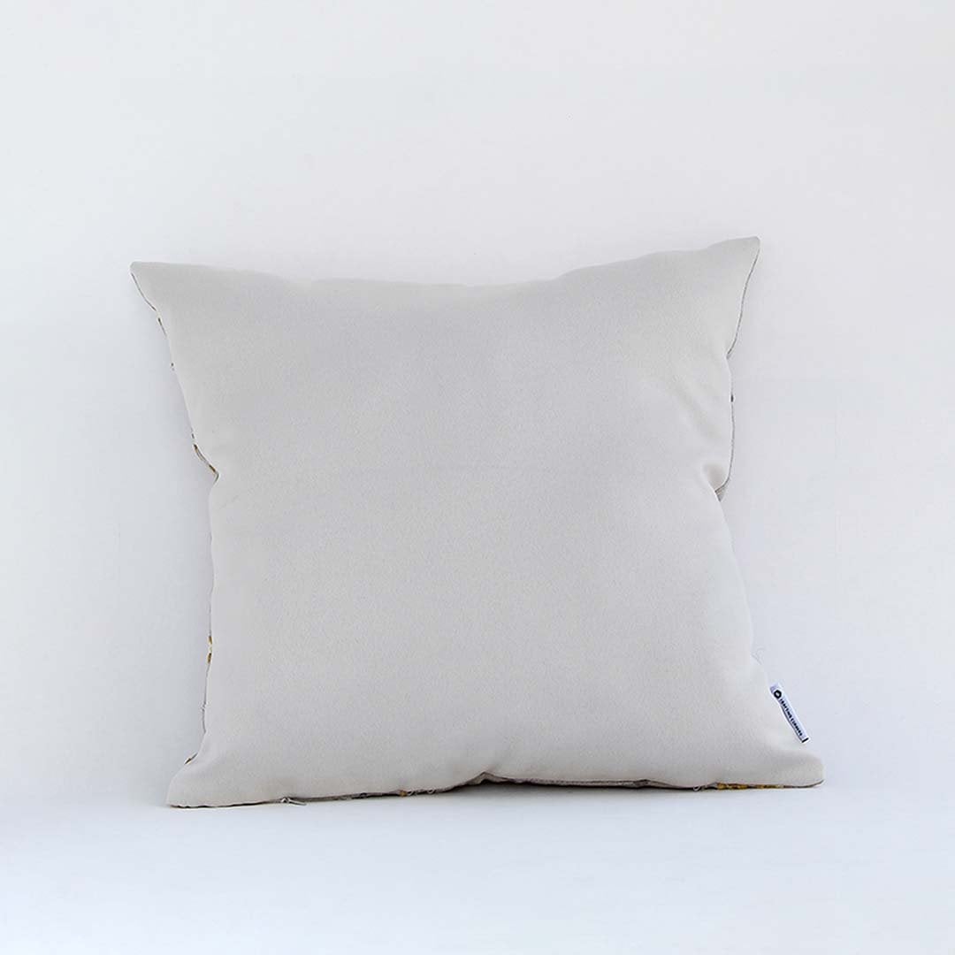 Backside of the cushion cover in a beige cotton fabric offering a smooth minimal décor style with a breathable soft and skin friendly material for daily comfort.
