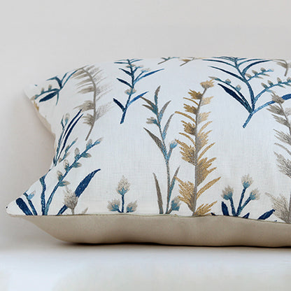 White cotton cushion cover with blue botanical leaf print for sofa bedroom seating and premium home decor styling.