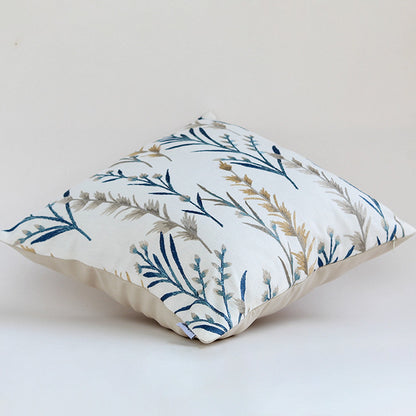 Square cushion with blue and gold botanical embroidery shown on a clean white background offering a minimal elegant and nature inspired decor look.