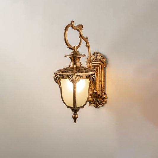 Luxury gold metal outdoor wall light on white background with a frosted glass tulip shade for elegant balcony decor.