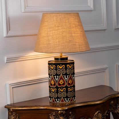 Festoon Damask table lamp illuminated on white background highlighting classic pattern warm glow and timeless interior decor elegance.