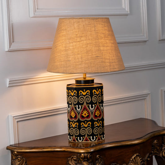 Festoon Damask table lamp illuminated on white background highlighting classic pattern warm glow and timeless interior decor elegance.